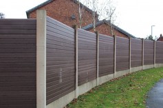 Walnut gravel boards fitted into existing concrete posts.